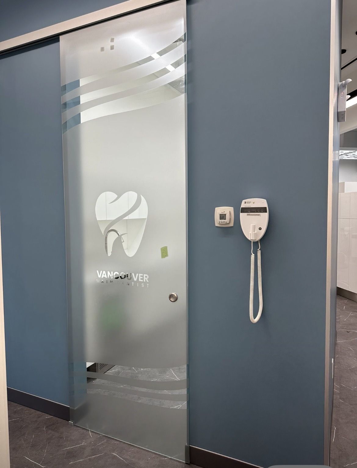 Frosted vinyl glass door with decorative wave pattern and logo for office privacy in Vancouver