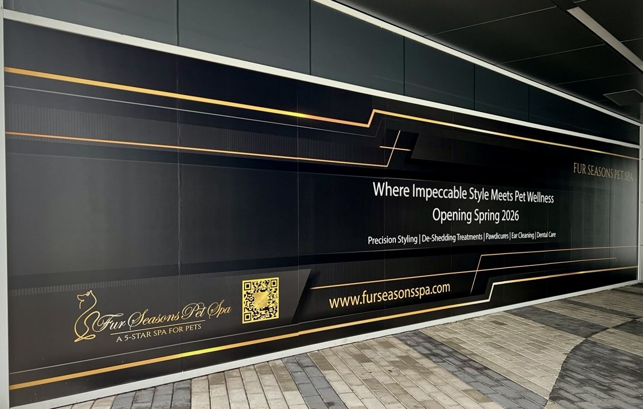 Wide large format printed wall graphic with gold accent lines for a coming-soon storefront in Vancouver