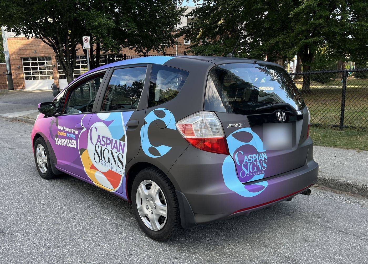 Full vehicle wrap with printed vinyl graphics on a Honda Fit in Vancouver