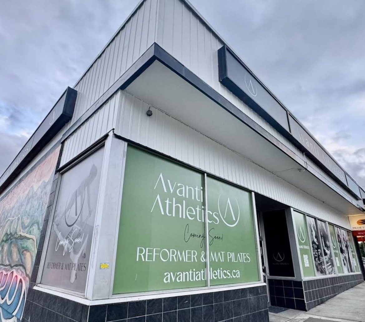 Printed window graphics and branded vinyl on a corner storefront in Metro Vancouver